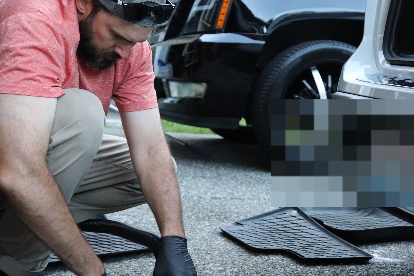 Cleaning floor mats curbside during a mobile detail