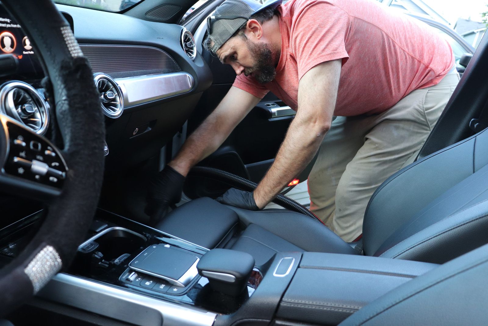 Detailer cleaning the center console and trim of a vehicle during a Pacific Northwest mobile detail