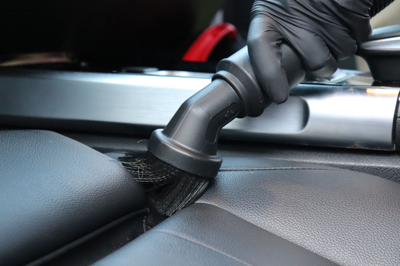 Detail-brushing the crevice between seat and console